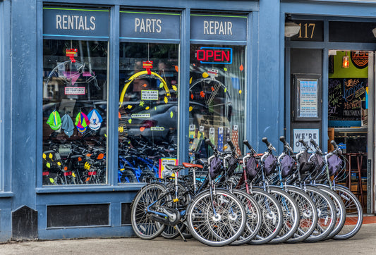 Bicycle rental and repair shop front with fleet of rental bikes outside